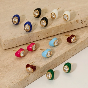 Vintage enamel earrings with zircon stones in multiple colors on marble surface