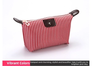 Detail of red striped fabric toiletry bag featuring brown leather trim and metal snap