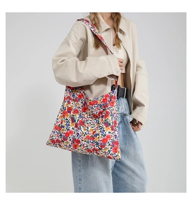 Floral canvas tote bag showing capacity and draping effect on model in studio