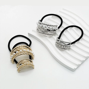 Detailed view of alloy hair bands with pearls and metal chains in gold and silver