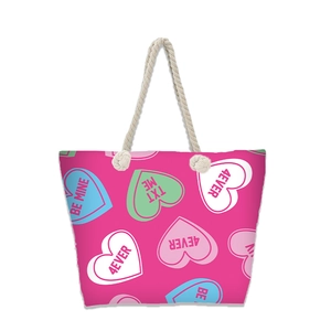 Detail of canvas beach tote with colorful heart prints and durable rope handles