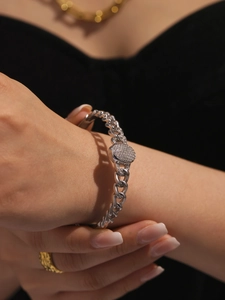 Detailed shot of a silver Cuban link bracelet with a round pave-set zircon centerpiece