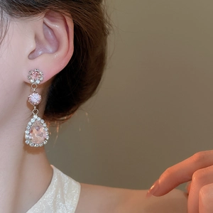 Close-up of pink teardrop earrings with crystals on model in vintage style
