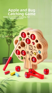 Detail of wooden apple tree toy showing numbered magnetic apples and a bug catching stick