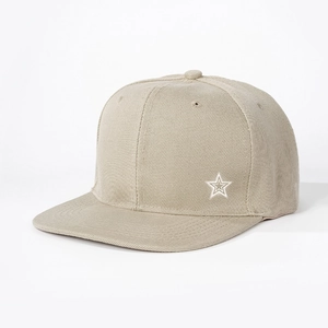 Detail view of beige flat brim baseball cap featuring a white star embroidery on the side