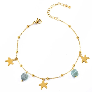 Golden starfish anklet with natural green stones and polished beads on a white background
