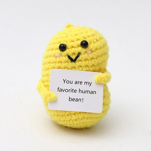 Close-up of yellow knitted bean toy holding a card saying You are my favorite human bean