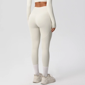 Detail of high-waist cream yoga pants showing V-shaped back seam and lift effect