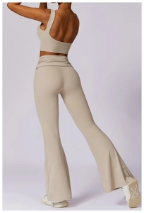 Rear view of beige high-waist flared yoga pants and racerback sports bra set