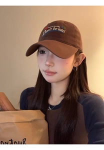 Detailed embroidery of Don't be late text on a vintage brown cotton baseball cap