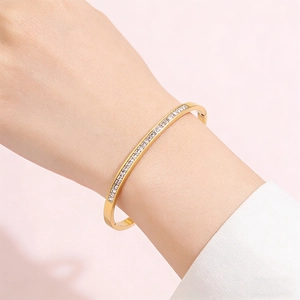 Detailed view of a gold-plated stainless steel bracelet with pave diamonds on wrist