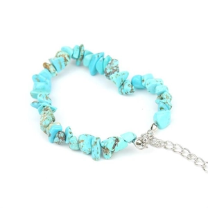 Macro view of heart-shaped natural turquoise stone bracelet with silver lobster clasp