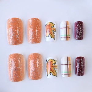 Autumn square press-on nails featuring orange glitter, maple leaf art and plaid patterns