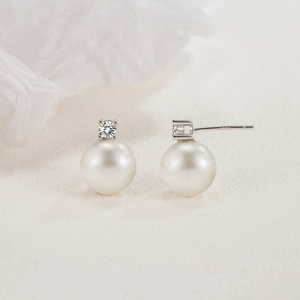Elegant S925 silver freshwater pearl stud earrings featuring a sparkling zircon accent