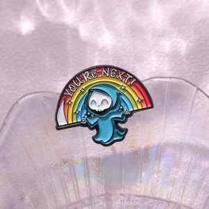 Rainbow reaper enamel pin featuring a cute grim reaper and You're Next text slogan