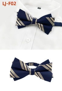 Detail of navy blue men bow tie with gold stripes on white shirt collar