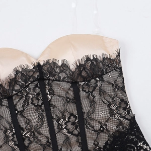 Detailed close-up of champagne satin cups with black eyelash lace on a corset dress