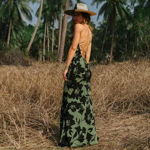 Detailed back view of a sexy backless floral maxi dress with slim spaghetti straps
