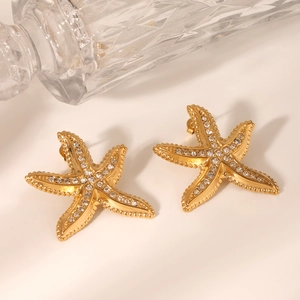 Detailed view of gold starfish earrings featuring sparkling rhinestones in an elegant setting