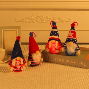 Knitted Independence Day gnome plush dolls with stars on a white table decoration