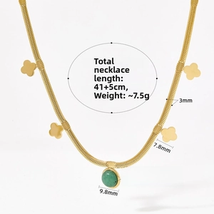 Detail of four-leaf clover necklace with green aventurine and golden snake chain specs
