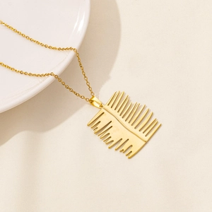 Detailed view of the gold-plated leaf pendant with a polished finish on an O-chain necklace