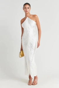 Detailed view of elegant white halter neck dress with cascading fringe layers and gold bag