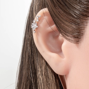 Sparkling crystal flower cartilage earring stud on ear in polished silver finish