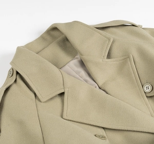 Detail of the khaki wool coat featuring a classic lapel collar and epaulet buttons