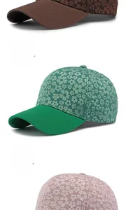 Close-up of floral jacquard texture on baseball caps in brown, green, and pink colors