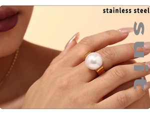 Detail of 18K gold plated stainless steel ring featuring a large white pearl on finger