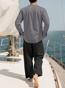 Vue arrière d'une chemise en lin gris foncé et d'un pantalon large noir sur un bateau