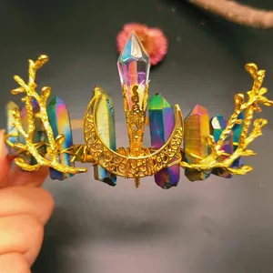 Close-up of rainbow aura quartz crystals and golden crescent moon on handmade crown