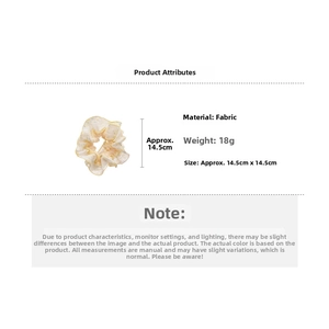 Detail view of yellow floral fabric scrunchie with 14.5cm size and 18g weight specs