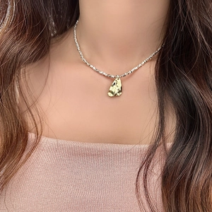 Elegant gold irregular geometric pendant on a silver bead chain necklace for women