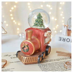 Detailed close-up of a red vintage train snow globe with Santa Claus and a Christmas tree