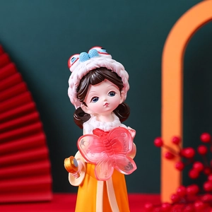 Detailed macro view of a cute girl figurine in orange Hanfu holding a red butterfly