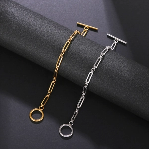 Detail of gold and silver chain bracelets with OT toggle clasps on black display stands