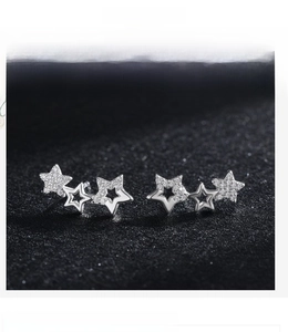 Macro view of S925 sterling silver star earrings with pave-set cubic zirconia and hollow design