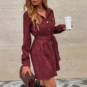 Detail view of burgundy corduroy shirt dress fabric texture and matching belt design