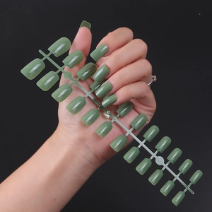 Macro view of long square olive green press-on nails with a glossy UV top coat finish