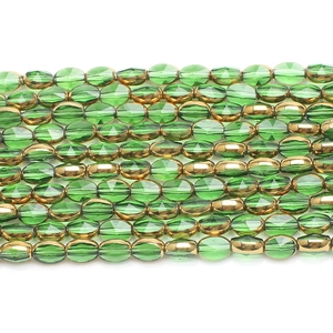 Macro detail of faceted green and gold glass beads for DIY jewelry making string