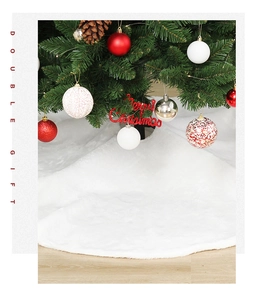 Close-up of soft white plush Christmas tree skirt texture on light wood flooring
