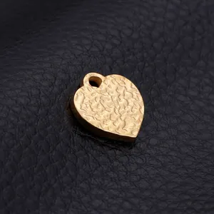 Golden heart pendant with hammered texture and water ripple pattern on black leather