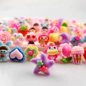Variety of colorful cartoon plastic rings for girls in pink, blue, and purple star shapes
