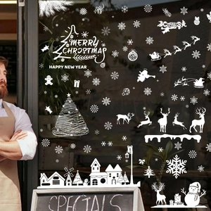 White Christmas window decals with snowflakes, Santa, and reindeer for festive holiday decor