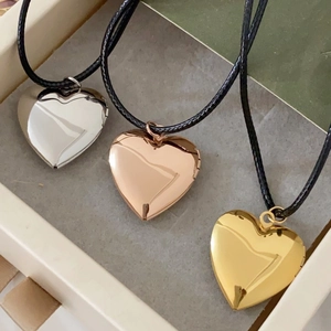 Polished heart locket necklaces in silver, gold, and rose gold with black cord straps