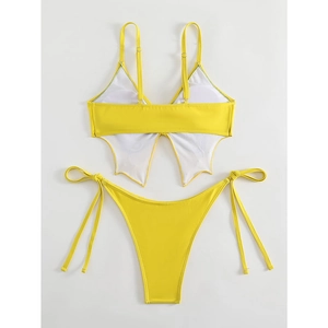 Detail of yellow bikini back featuring unique white butterfly wing splice decoration