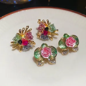 Floral stud earrings set with colorful enamel blossoms and sparkling rhinestones