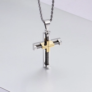 Close-up of two-tone stainless steel cross pendant with gold wire weave and silver chain